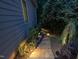 Beautifully landscaped walkway with stone steps and accent lighting, enhancing curb appeal at night at 105 Highlands Lake Dr, Cary, NC 27518
