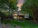 Stunning backyard featuring a stone fire pit, multi-tiered deck and lush landscaping at 105 Highlands Lake Dr, Cary, NC 27518