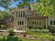 Exterior of the home featuring a multi-level deck with outdoor seating and lush landscaping at 105 Highlands Lake Dr, Cary, NC 27518