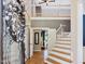 Inviting foyer with hardwood floors, staircase, and view to second story loft at 105 Highlands Lake Dr, Cary, NC 27518