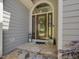 Elegant front door with stone steps and decorative lantern, adding a welcoming touch at 105 Highlands Lake Dr, Cary, NC 27518