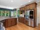 Modern kitchen with granite countertops, stainless steel appliances, and eat in breakfast area at 105 Highlands Lake Dr, Cary, NC 27518
