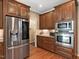 Stylish kitchen with stainless steel appliances, wood cabinets, and granite countertops at 105 Highlands Lake Dr, Cary, NC 27518