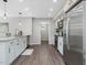 Eat-in kitchen featuring stainless appliances, white cabinets, granite countertops, and hardwood floors at 105 Highlands Lake Dr, Cary, NC 27518