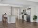 Modern eat-in kitchen featuring stainless steel appliances, a granite countertop, and white cabinets at 105 Highlands Lake Dr, Cary, NC 27518