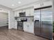 Bright kitchen features stainless steel appliances, white cabinetry, and granite countertops at 105 Highlands Lake Dr, Cary, NC 27518