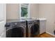 Laundry room boasting new washer and dryer units, plus a storage and folding counter at 105 Highlands Lake Dr, Cary, NC 27518