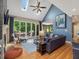 Bright living room featuring hardwood floors, skylights, and access to an outdoor deck at 105 Highlands Lake Dr, Cary, NC 27518