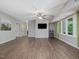 Spacious living room with hardwood floors, large windows, a ceiling fan, and a mounted television at 105 Highlands Lake Dr, Cary, NC 27518