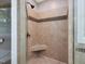 The shower is tiled with a neutral mosaic at 105 Highlands Lake Dr, Cary, NC 27518