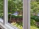 A beautiful view of the pond and lush yard visible from the window at 105 Highlands Lake Dr, Cary, NC 27518