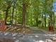 Picturesque walking trail featuring benches, mature trees, and dog waste stations at 105 Highlands Lake Dr, Cary, NC 27518