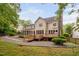 Expansive backyard featuring multiple decks, a screened in porch, lush lawn, and mature trees at 108 Nimbus Ct, Cary, NC 27513