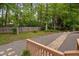A view of the backyard featuring a rock path, a wooded fence line, and mature trees at 108 Nimbus Ct, Cary, NC 27513