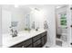 Bathroom featuring a double vanity with a white countertop, dark wood cabinets, and updated fixtures at 108 Nimbus Ct, Cary, NC 27513