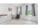 Bedroom featuring two windows, neutral carpet, updated fixtures, and natural light at 108 Nimbus Ct, Cary, NC 27513