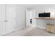 Bright bedroom featuring carpet, white doors and trim, desk, and a glimpse into an adjacent room at 108 Nimbus Ct, Cary, NC 27513