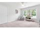 Bright and airy room with a gray chair, large window, and neutral carpet at 108 Nimbus Ct, Cary, NC 27513