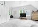 Bonus room featuring ample space, neutral carpet, windows, ceiling fan, and storage drawers at 108 Nimbus Ct, Cary, NC 27513