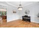 Formal dining room with hardwood floors, wainscoting, chandelier, and doorway to another room at 108 Nimbus Ct, Cary, NC 27513