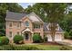 Beautiful brick home with a classic design, lush landscaping, and a welcoming two-car garage at 108 Nimbus Ct, Cary, NC 27513