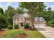 Charming two-story brick home with a well-manicured lawn, mature trees, and an attached two-car garage at 108 Nimbus Ct, Cary, NC 27513