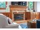 Close-up view of brick fireplace with custom wood mantel and built-in cabinetry at 108 Nimbus Ct, Cary, NC 27513