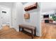 Entry hallway featuring hardwood floors, coat rack, and access to a bathroom at 108 Nimbus Ct, Cary, NC 27513
