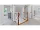 Hallway featuring a staircase with wood railing, plush carpet, and white paint throughout at 108 Nimbus Ct, Cary, NC 27513