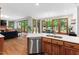 Open-concept kitchen flowing into a living area, featuring stainless steel appliances and abundant natural light at 108 Nimbus Ct, Cary, NC 27513