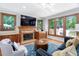 Cozy living room with brick fireplace, custom built-ins, large windows and comfortable seating at 108 Nimbus Ct, Cary, NC 27513