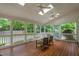 Relaxing screened porch with views of the fenced-in backyard and wooded property at 108 Nimbus Ct, Cary, NC 27513