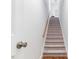 Carpeted staircase with wooden handrail leading to the upper level of the home at 108 Nimbus Ct, Cary, NC 27513