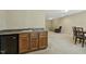 A finished basement featuring a wet bar, cabinetry, and seating area, perfect for entertaining at 109 Lyngrove St, Holly Springs, NC 27540