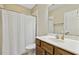 Well-lit bathroom with a single sink vanity, toilet and shower with white curtain at 109 Lyngrove St, Holly Springs, NC 27540