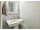 Classic pedestal sink in a neutral-toned powder room, perfect for guests at 109 Lyngrove St, Holly Springs, NC 27540