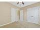 Neutral bedroom with a ceiling fan, carpet and multiple closet spaces at 109 Lyngrove St, Holly Springs, NC 27540