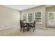 This neutral basement features a dinette with a table, four chairs and large windows for natural light at 109 Lyngrove St, Holly Springs, NC 27540