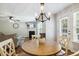 Cozy dining area with hardwood floors, pendant lighting, and views of the living room at 109 Lyngrove St, Holly Springs, NC 27540