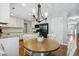 Bright breakfast area with a round table, white cabinets, and stainless-steel appliances at 109 Lyngrove St, Holly Springs, NC 27540