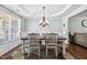 Elegant dining room with stylish chandelier and large windows at 109 Lyngrove St, Holly Springs, NC 27540