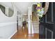 Inviting entryway with gleaming hardwood floors and staircase, offering a warm welcome at 109 Lyngrove St, Holly Springs, NC 27540