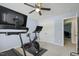 This exercise room has carpet, ceiling fan and exercise equipment like treadmill and a stationary bike at 109 Lyngrove St, Holly Springs, NC 27540