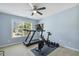 This exercise room has a ceiling fan, light-blue walls, and an exercise bike and treadmill at 109 Lyngrove St, Holly Springs, NC 27540