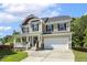 Charming two-story home featuring a welcoming front porch and well-maintained landscaping at 109 Lyngrove St, Holly Springs, NC 27540
