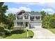 Charming two-story home featuring a welcoming front porch and well-maintained landscaping at 109 Lyngrove St, Holly Springs, NC 27540
