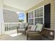 Cozy front porch with comfortable seating, perfect for relaxing and enjoying the outdoors at 109 Lyngrove St, Holly Springs, NC 27540