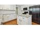 Modern kitchen with white cabinets, granite countertops, stainless appliances and center island for prep and entertaining at 109 Lyngrove St, Holly Springs, NC 27540
