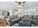 Spacious living room featuring hardwood floors, an ottoman, and comfortable sofas at 109 Lyngrove St, Holly Springs, NC 27540