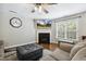 Comfortable living room featuring a fireplace, hardwood floors, and a ceiling fan at 109 Lyngrove St, Holly Springs, NC 27540